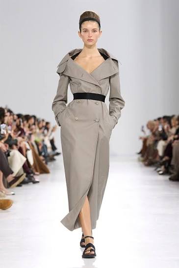 Max Mara Spring/Summer 2027 runway look featuring a belted taupe trench-inspired silhouette.